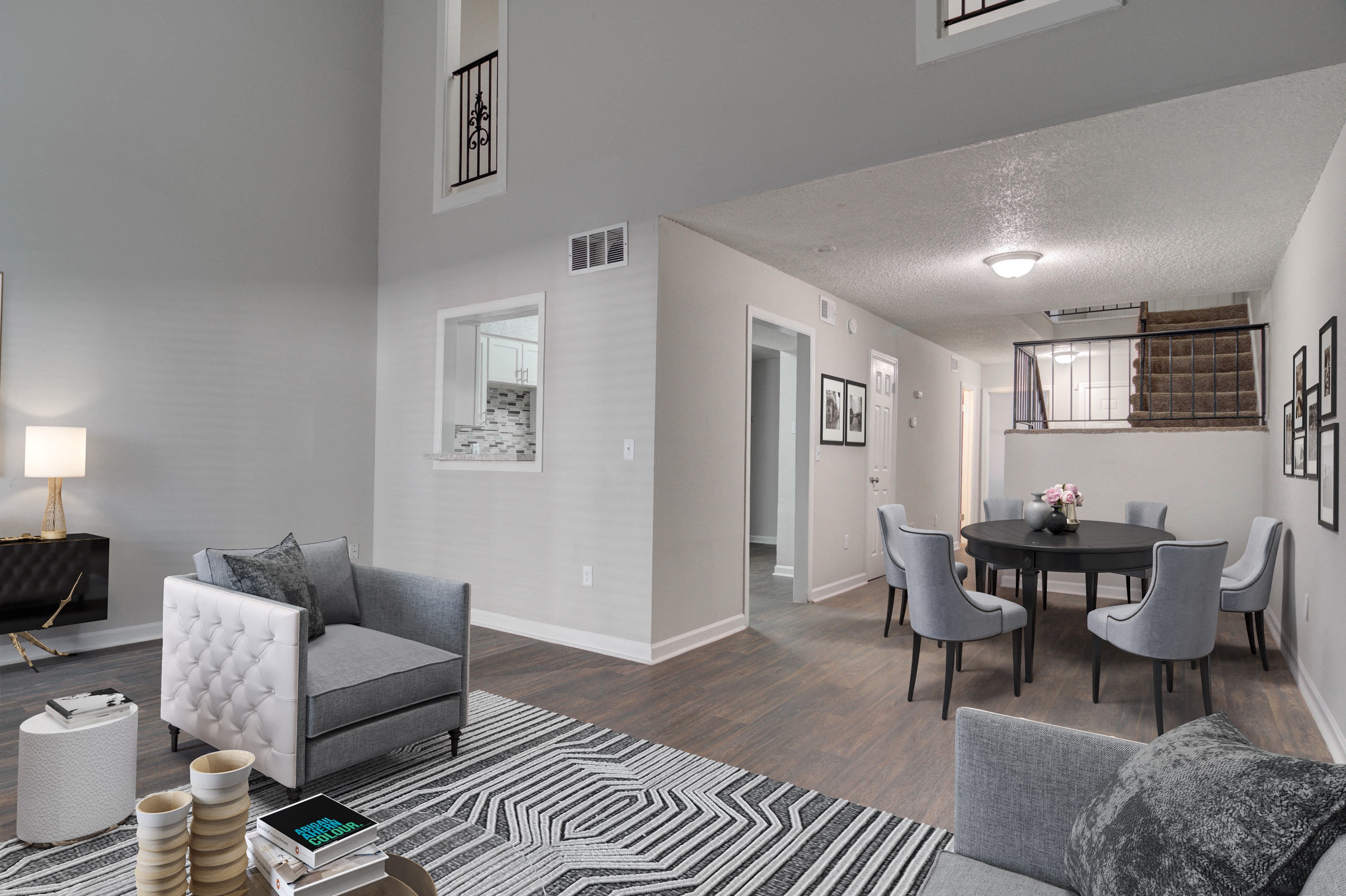 Living room and dining area at Mirador at Idlewood in Clarkston, Georgia, featuring sleek wood-style plank flooring, spacious layout, and natural lighting.